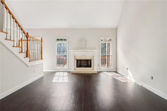 unfurnished living room with wood-type flooring and vaulted ceiling