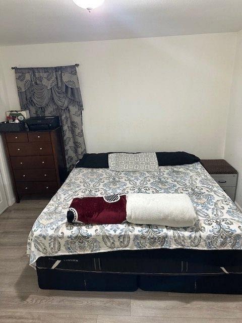 bedroom with light wood finished floors