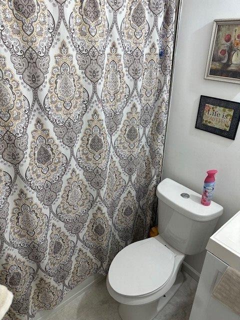 bathroom with toilet, tile patterned flooring, and vanity