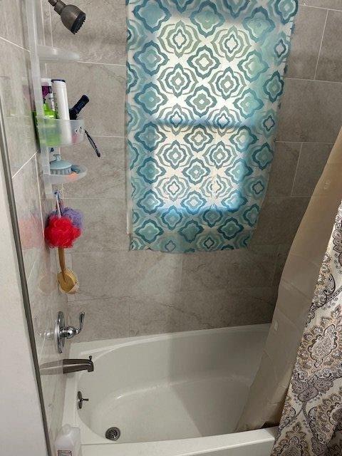 full bathroom with shower / bath combination with curtain