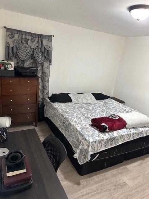 bedroom featuring light wood-style flooring