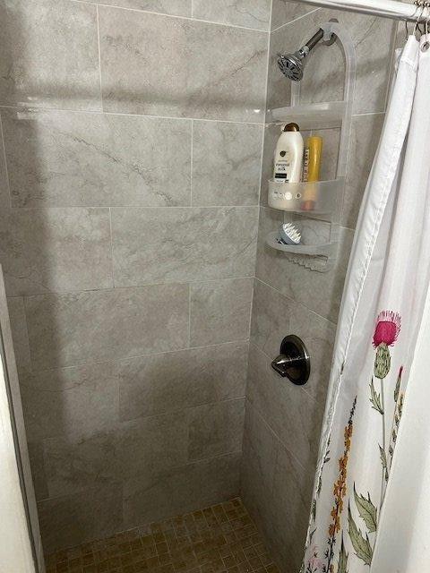 bathroom with a tile shower