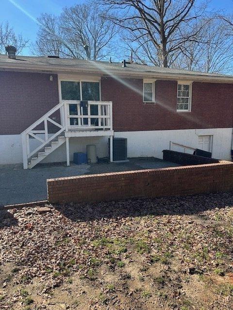 rear view of house with brick siding