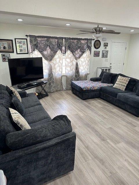 living room with ceiling fan, wood finished floors, and recessed lighting
