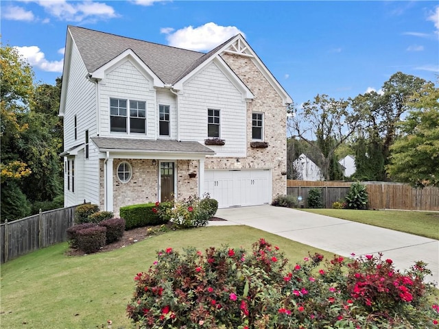 view of property featuring a front lawn and a garage