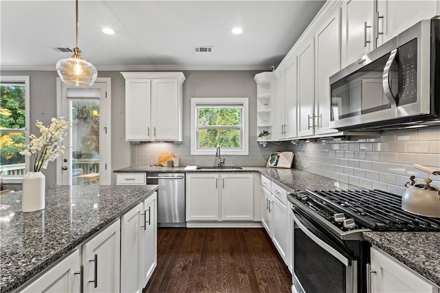 kitchen with white cabinets, stainless steel appliances, a healthy amount of sunlight, and sink