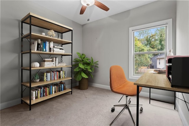 carpeted office space featuring ceiling fan