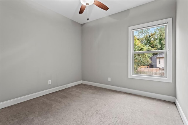 spare room featuring carpet flooring and ceiling fan