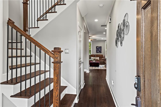 entrance foyer with dark hardwood / wood-style floors and ornamental molding