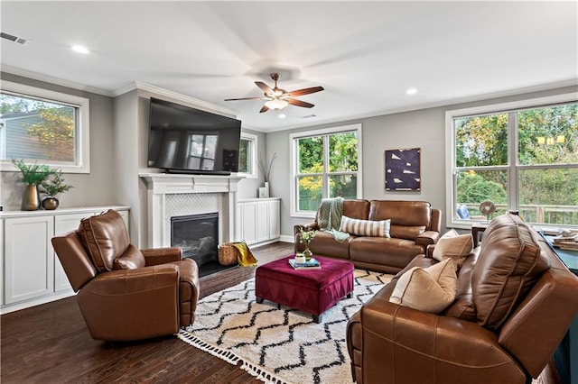 living room with crown molding, plenty of natural light, and dark wood-type flooring