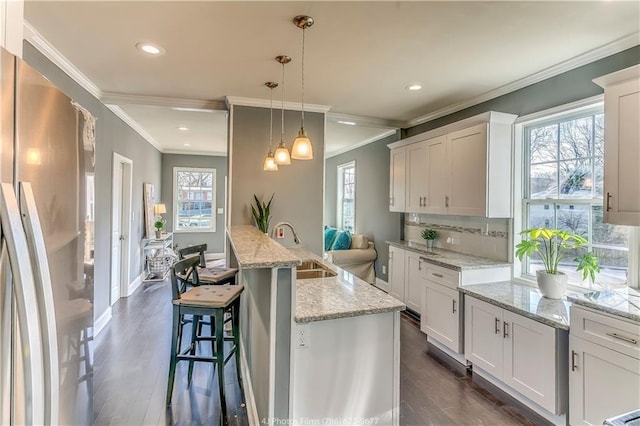 385 Arthur St SW, Atlanta, GA 30310 - kitchen with tasteful backsplash, dark wood-type flooring, pendant lighting, freestanding refrigerator, and white cabinets