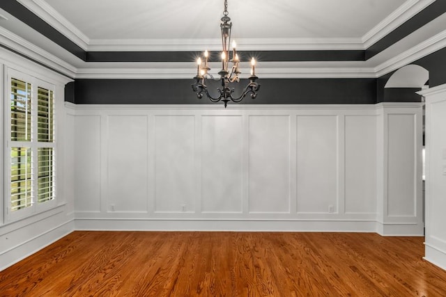 201 Hunley Ct, Alpharetta, GA 30005 - unfurnished dining area with a decorative wall, ornamental molding, a chandelier, and wood finished floors