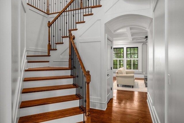 201 Hunley Ct, Alpharetta, GA 30005 - stairway featuring coffered ceiling, wood finished floors, a ceiling fan, arched walkways, and baseboards