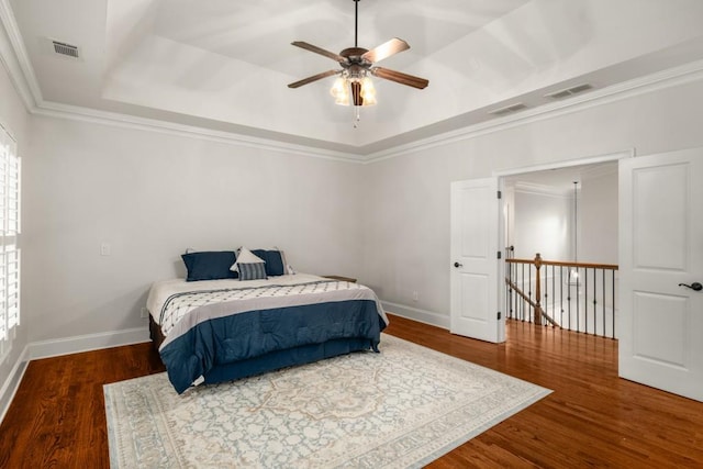 201 Hunley Ct, Alpharetta, GA 30005 - bedroom with visible vents, wood finished floors, and a tray ceiling
