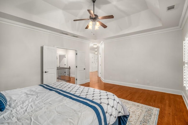201 Hunley Ct, Alpharetta, GA 30005 - bedroom with baseboards, visible vents, wood finished floors, crown molding, and a raised ceiling