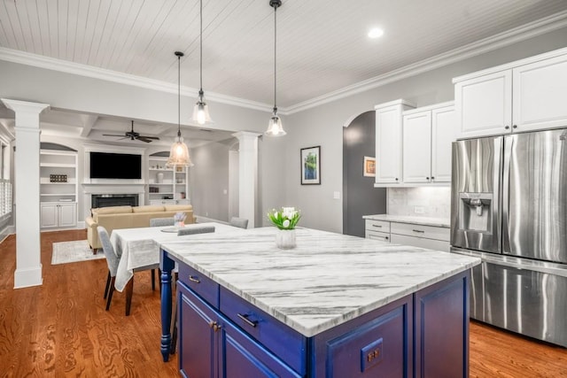 201 Hunley Ct, Alpharetta, GA 30005 - kitchen with a ceiling fan, blue cabinets, a fireplace, stainless steel refrigerator with ice dispenser, and ornate columns