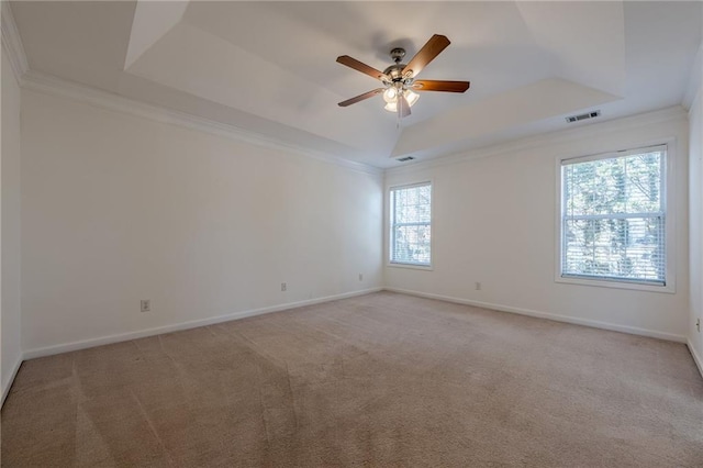 unfurnished room with crown molding, light colored carpet, ceiling fan, and a tray ceiling