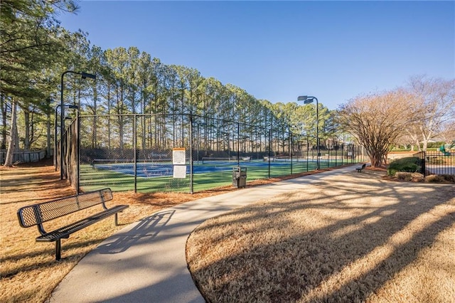 view of home's community with tennis court