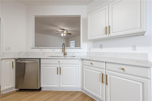 kitchen with white cabinetry, dishwasher, sink, light wood-type flooring, and a textured ceiling