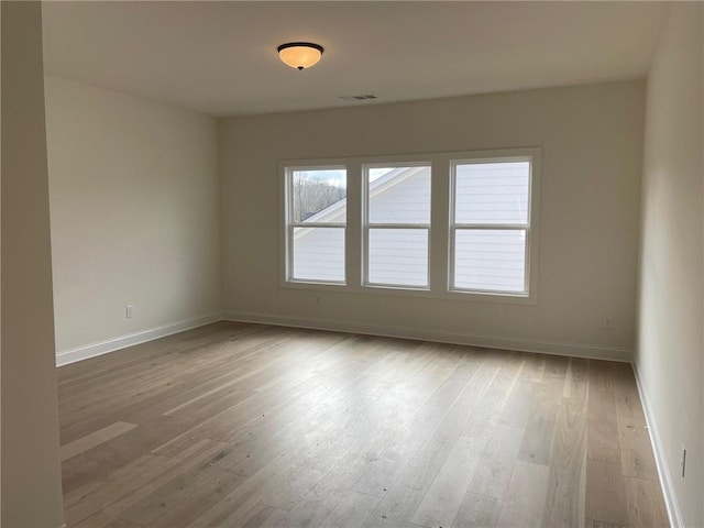 unfurnished room with light hardwood / wood-style flooring