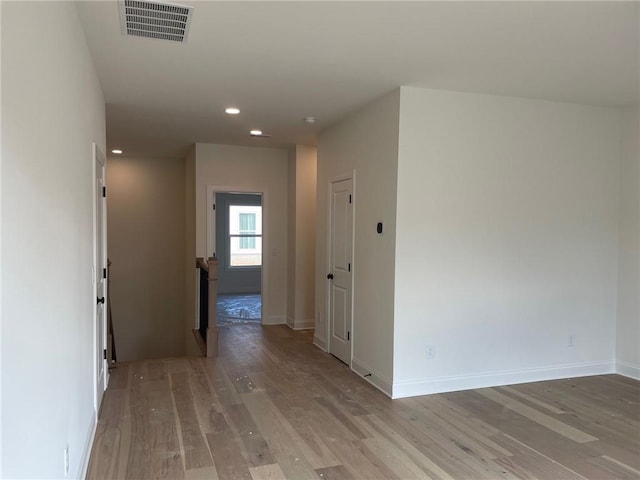 hallway with light hardwood / wood-style floors