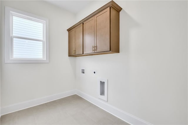 laundry area featuring cabinet space, hookup for a washing machine, baseboards, and electric dryer hookup