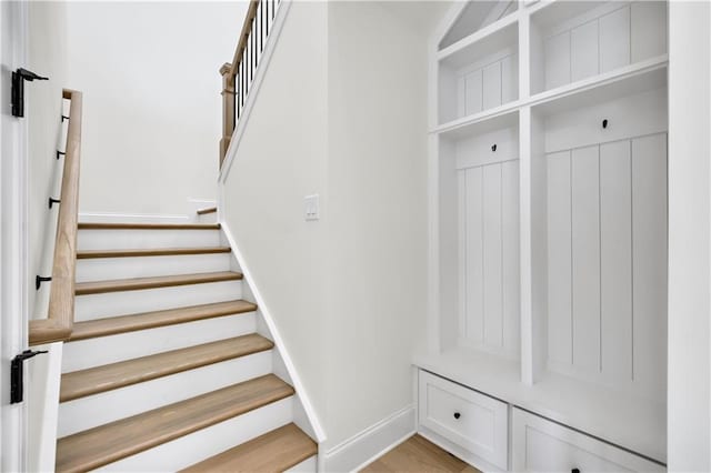 mudroom featuring light wood-type flooring and baseboards