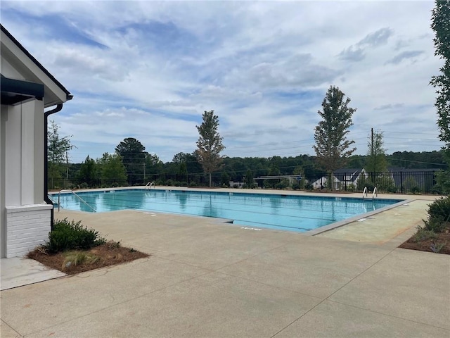 pool featuring a patio and fence