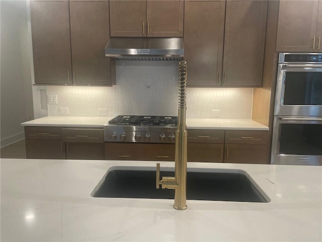 kitchen with stainless steel appliances and dark brown cabinets