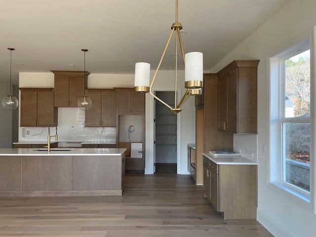 kitchen featuring sink, pendant lighting, and backsplash