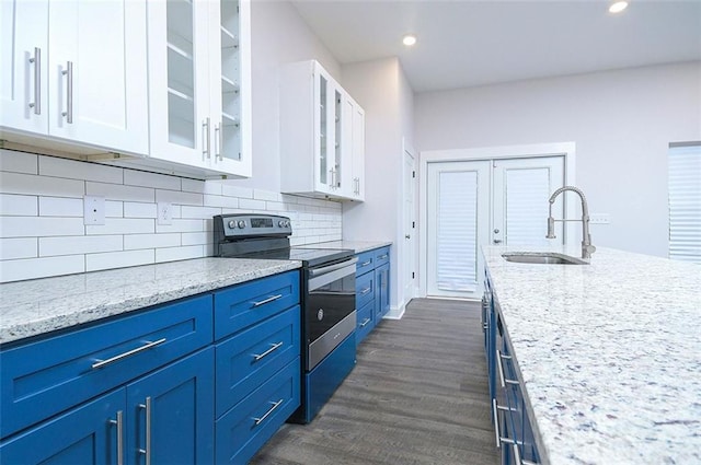 kitchen featuring stainless steel range with electric stovetop, white cabinets, blue cabinets, sink, and tasteful backsplash