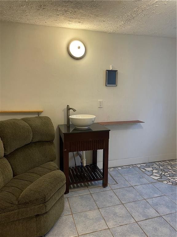 304 E 19th St SW, Rome, GA 30161 - bathroom with a textured ceiling, tile patterned flooring, baseboards, and vanity