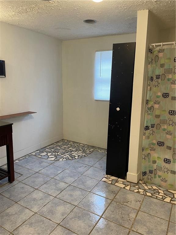 304 E 19th St SW, Rome, GA 30161 - unfurnished dining area featuring a textured ceiling and baseboards