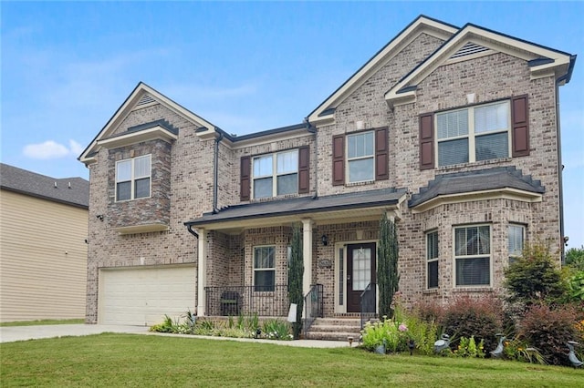 view of front of house with a garage and a front lawn