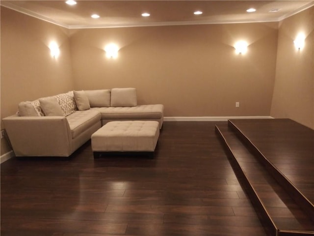 home theater room featuring crown molding and dark wood-type flooring