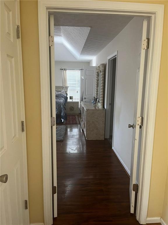 corridor with dark hardwood / wood-style floors