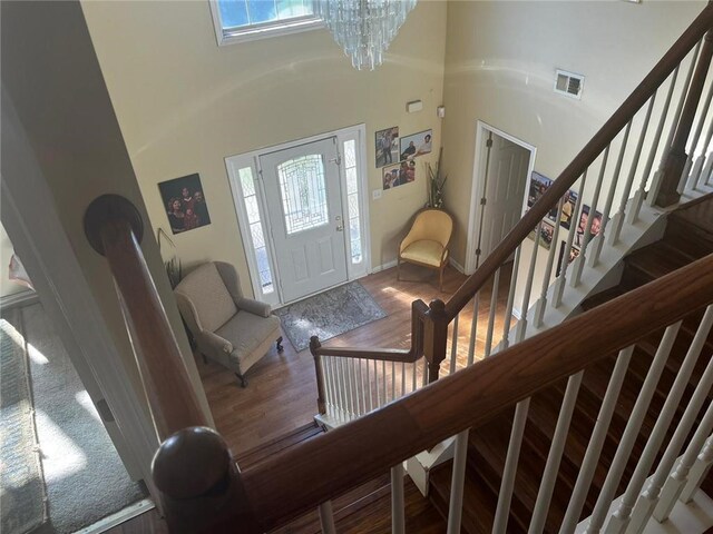 entrance foyer featuring a towering ceiling and a chandelier