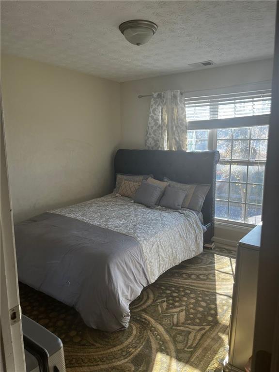 bedroom featuring a textured ceiling