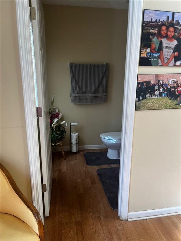 bathroom with hardwood / wood-style floors and toilet