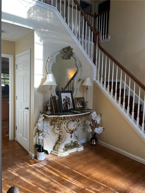 stairs featuring hardwood / wood-style flooring