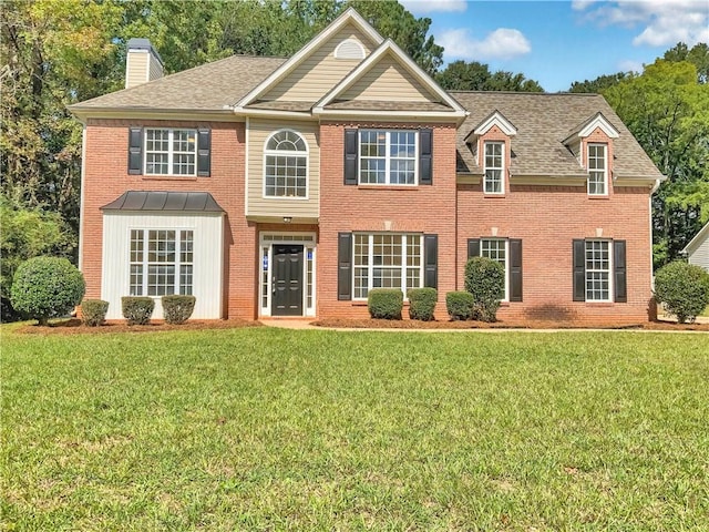 colonial-style house with a front lawn