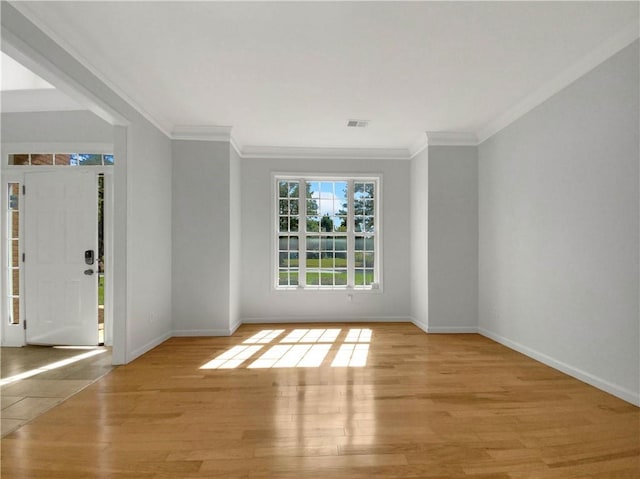 unfurnished room with ornamental molding and light hardwood / wood-style floors