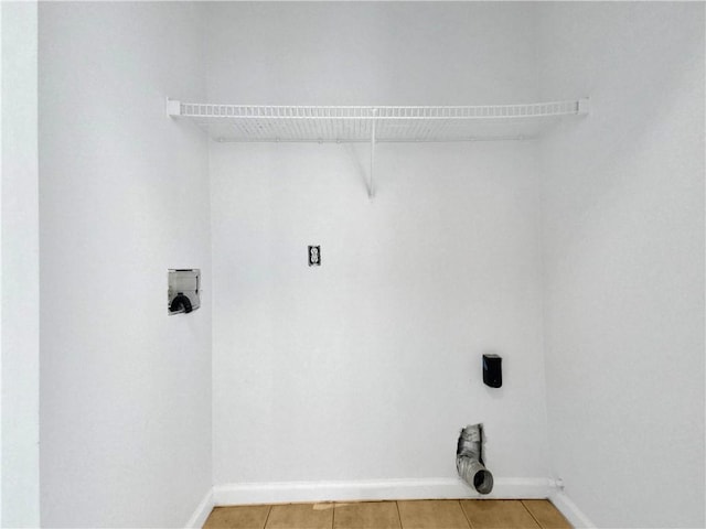 washroom with hookup for a washing machine and tile patterned floors