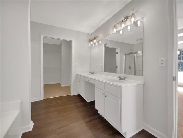 bathroom featuring independent shower and bath, hardwood / wood-style flooring, and vanity