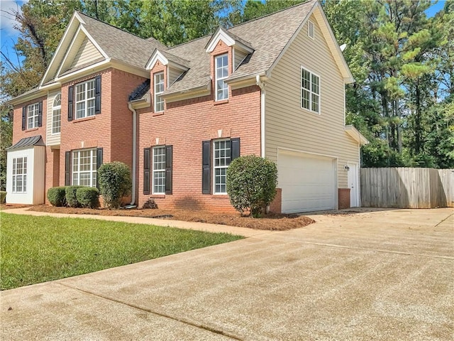 view of front facade with a garage and a front yard