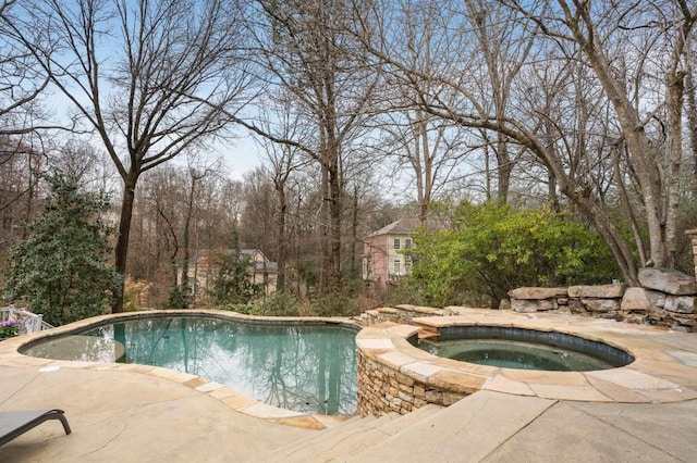 view of pool featuring an in ground hot tub and a patio area