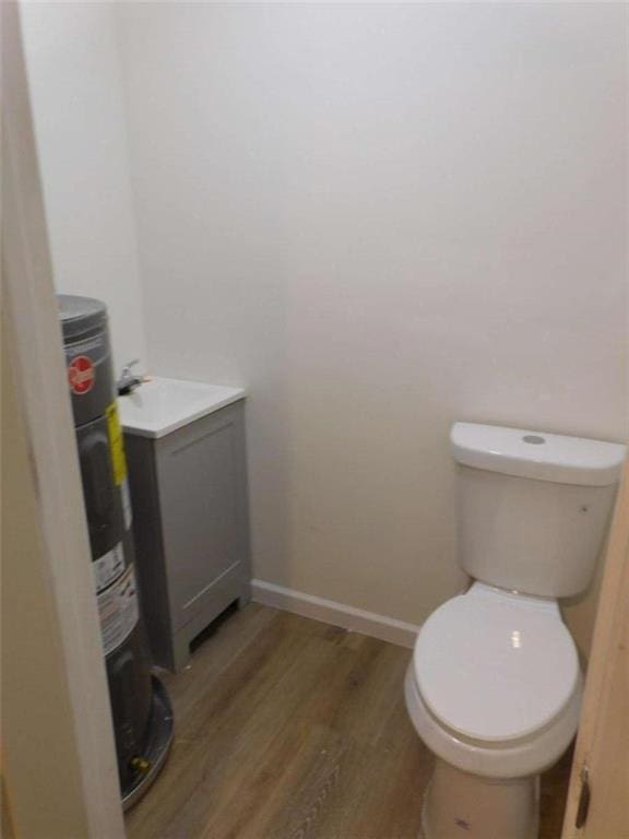 476 W Franklin St, Toccoa, GA 30577 - bathroom with wood finished floors, electric water heater, and vanity