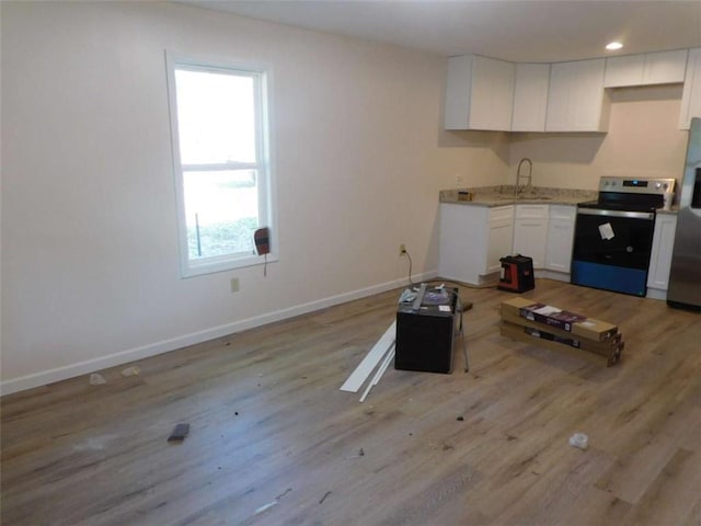 476 W Franklin St, Toccoa, GA 30577 - kitchen with stainless steel appliances, white cabinets, light wood finished floors, light countertops, and recessed lighting