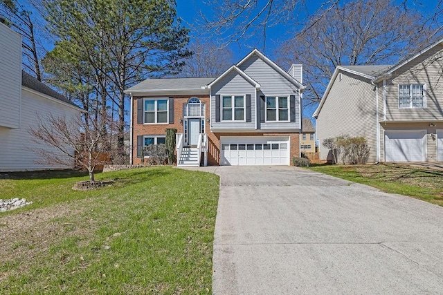 split foyer home featuring brick siding, a chimney, and a front lawn