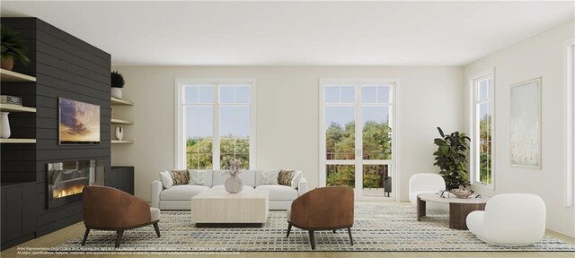 living room with a large fireplace and light hardwood / wood-style floors